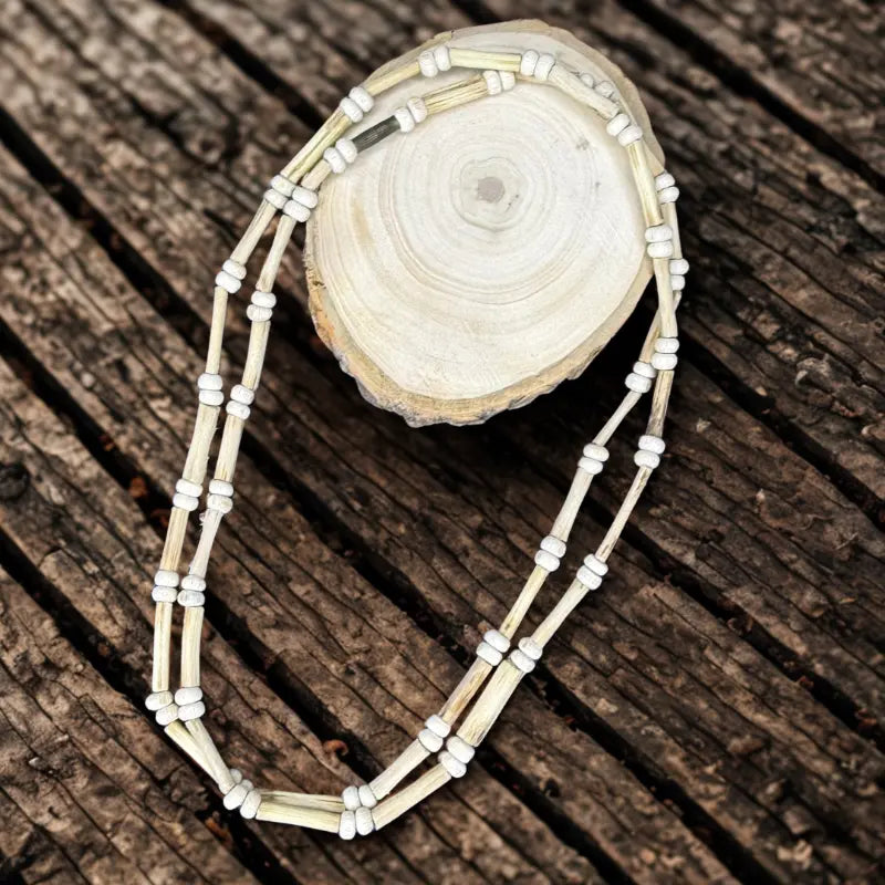 Necklace with white beads on a wooden surface