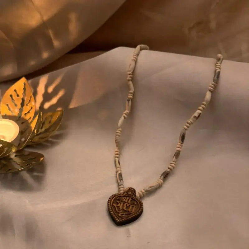 Necklace with a heart-shaped pendant on a soft fabric background