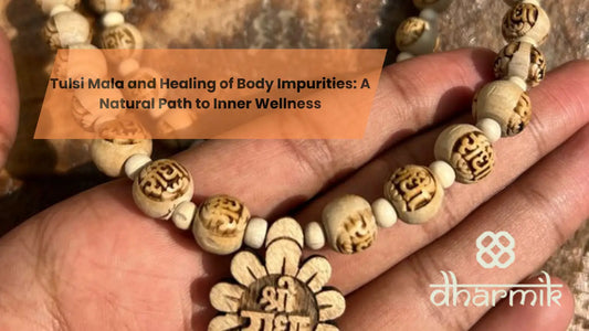 Tulsi mala beads with carved sacred symbols held in hand, representing spiritual healing, purity, and inner wellness.
