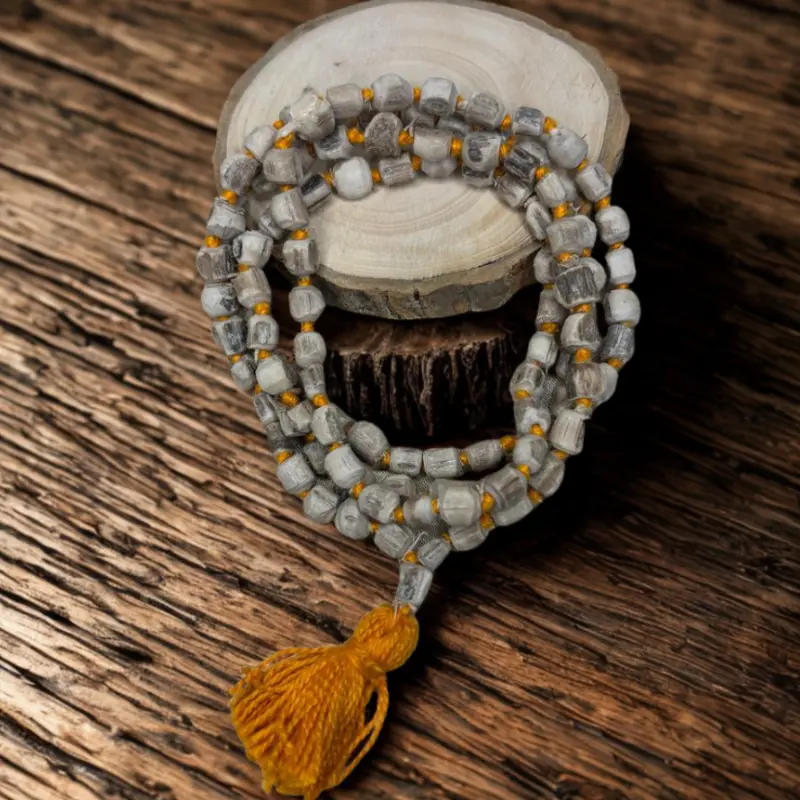 Beaded necklace with a tassel on a wooden surface
